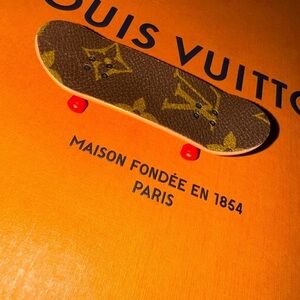 Miniature Skateboard with a hotdog design on the bottom​